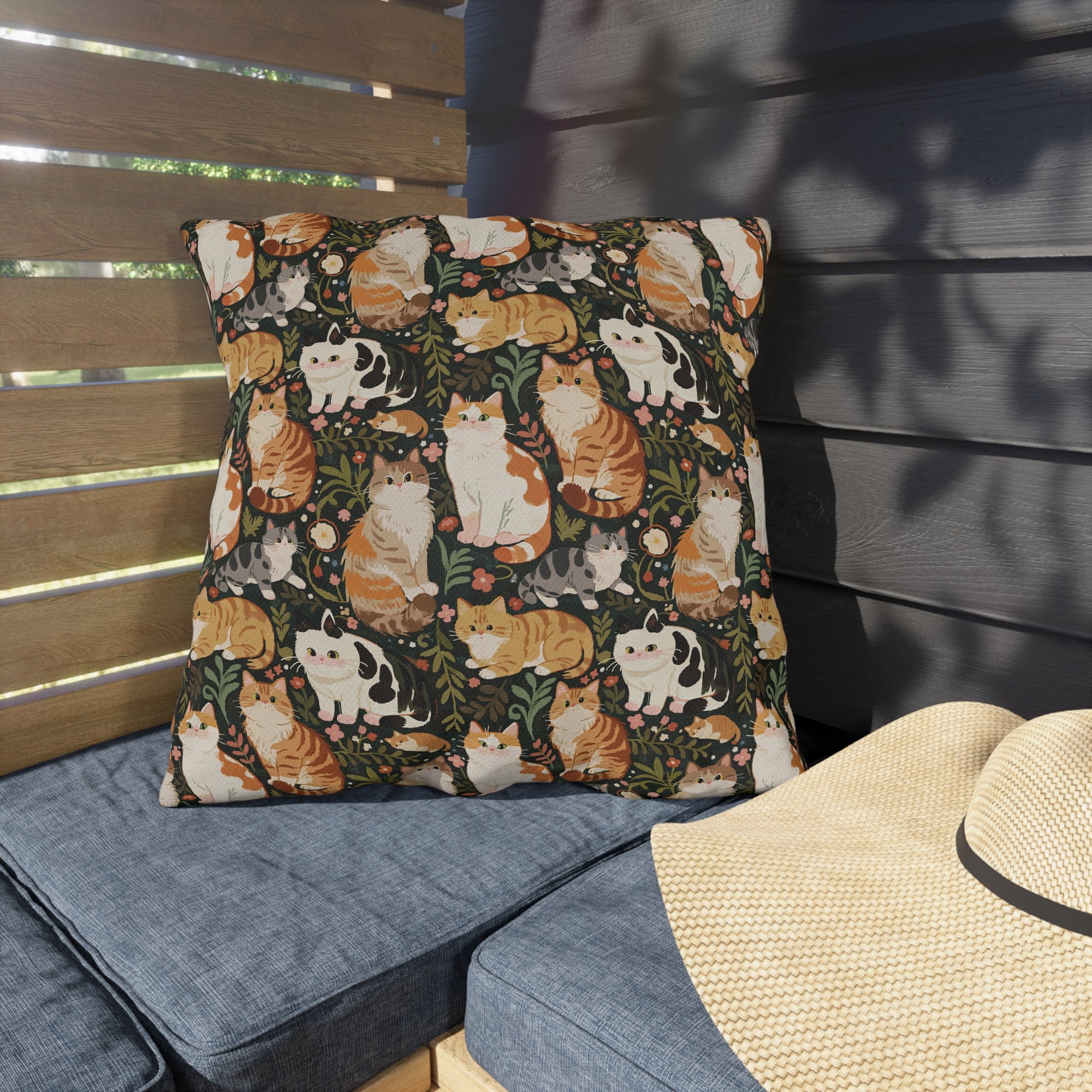Outdoor Pillow - Whimsical cat and kitten garden party, various cat breeds amidst green foliage and pink flowers, charming animal illustration, dark forest green background, playful and natural art
