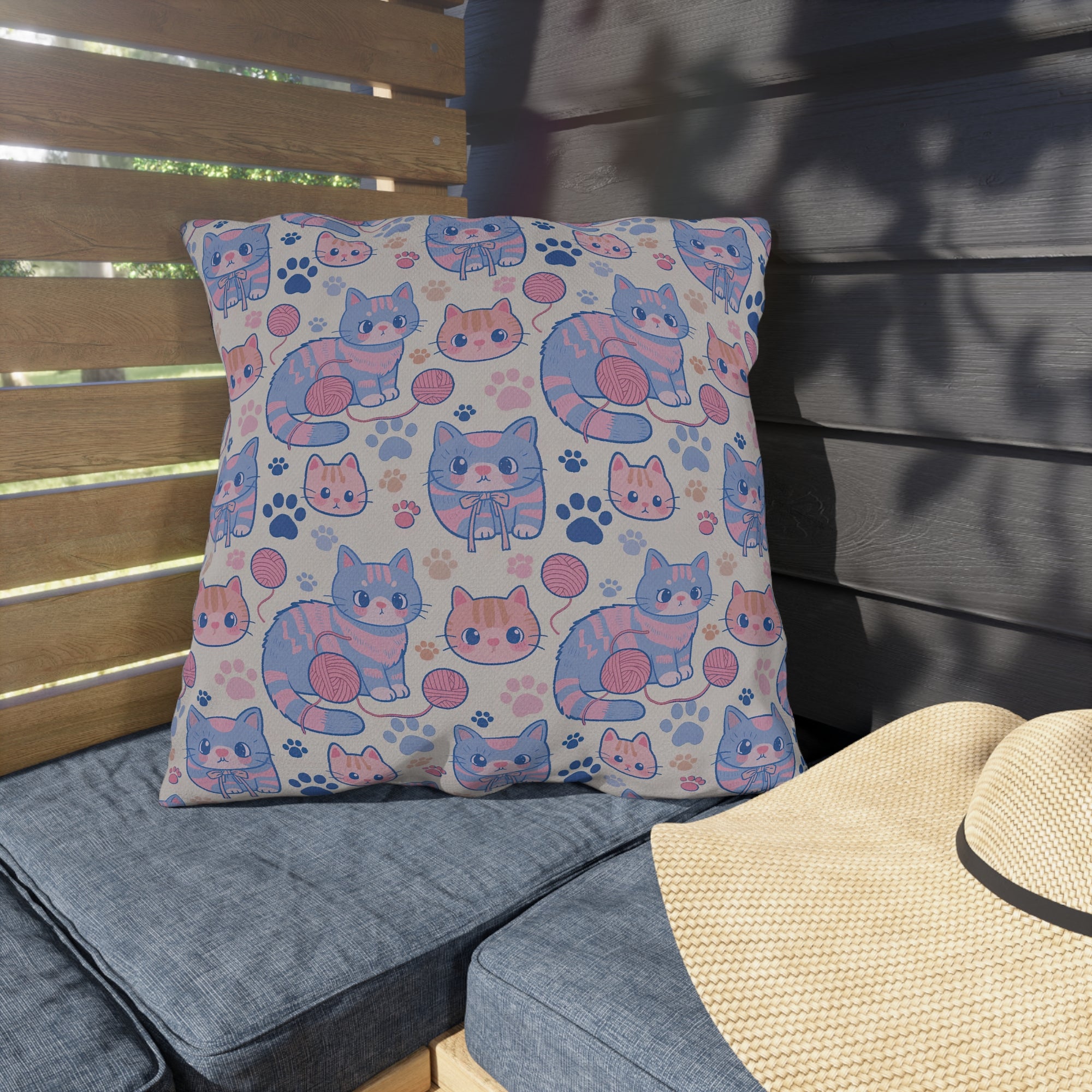 Outdoor Pillow - Sweet pastel blue and pink cartoon cats, cute kawaii style kittens with yarn and paw prints, charming and playful animal design, light cream background, delightful pet pattern