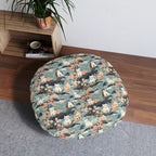Indoor Round Floor Pillow - A serene watercolor painting of fluffy cats lounging on rocks, surrounded by cherry blossoms and blue water, in a tranquil, nature-filled, Japanese-inspired landscape.
