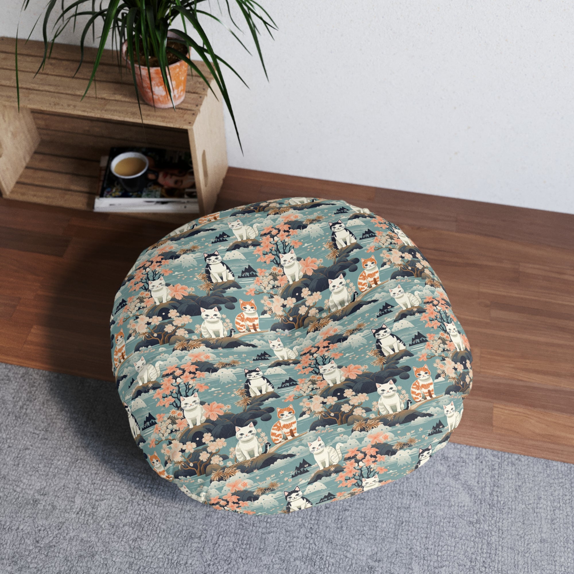 Indoor Round Floor Pillow - A serene watercolor painting of fluffy cats lounging on rocks, surrounded by cherry blossoms and blue water, in a tranquil, nature-filled, Japanese-inspired landscape.