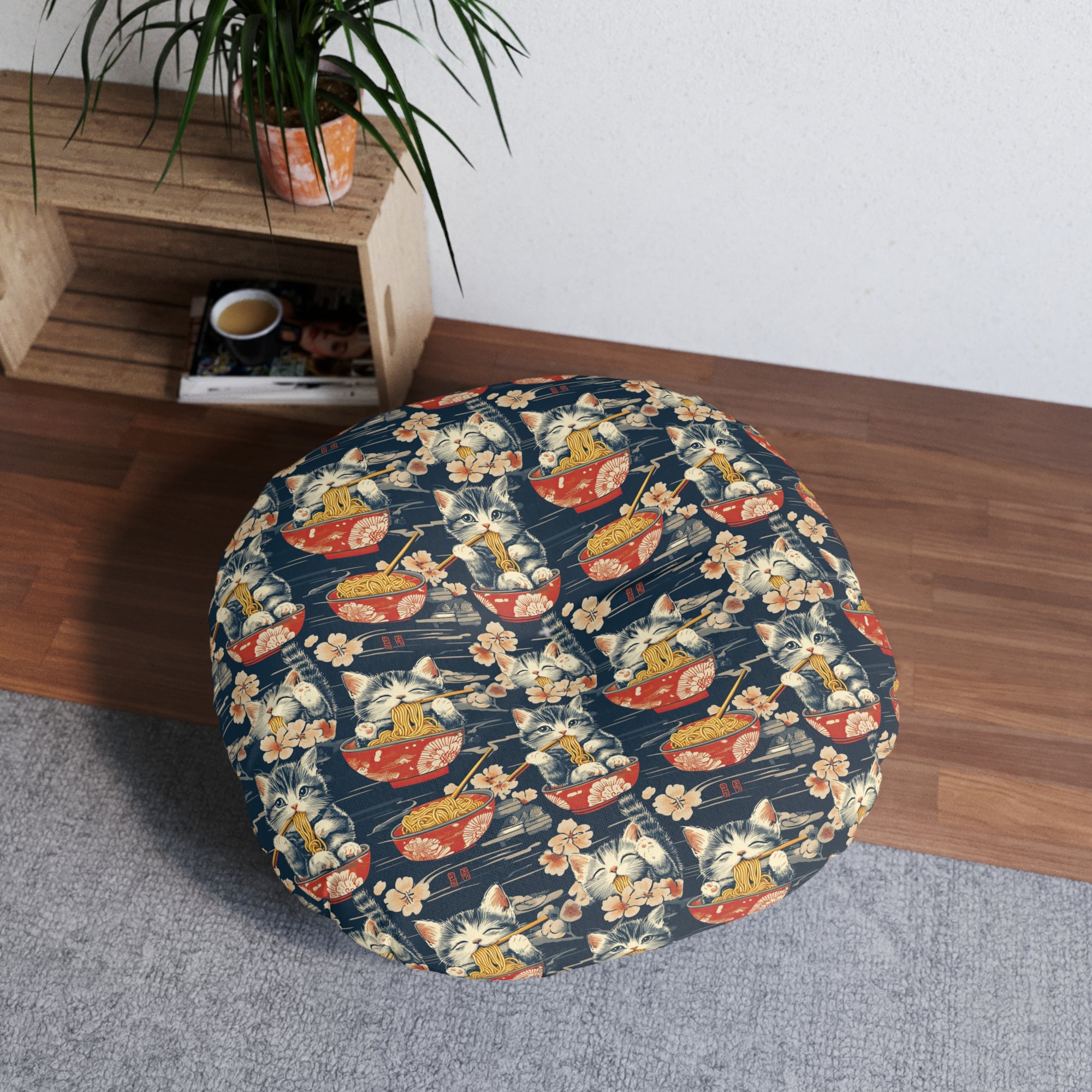 Indoor Round Floor Pillow - A charming and detailed illustration of happy kittens in red ramen bowls eating their noodles with chopsticks among beautiful pink cherry blossoms on a dark background.