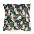 Outdoor Pillow - A whimsical, fluffy, watercolor depiction of various cats of different colors peeking out from a dense dark blue and green bush with white flowers.