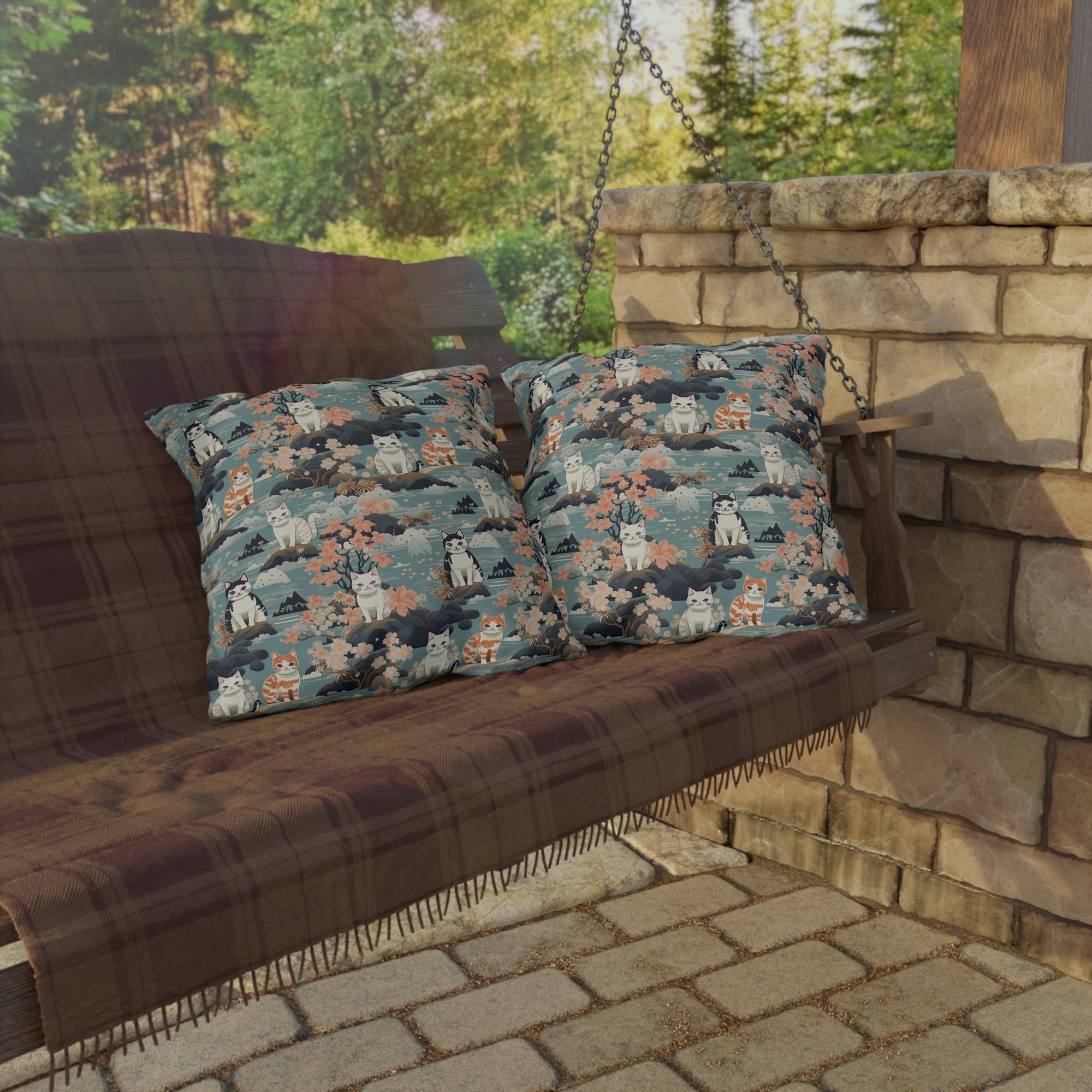 Outdoor Pillow - A serene watercolor painting of fluffy cats lounging on rocks, surrounded by cherry blossoms and blue water, in a tranquil, nature-filled, Japanese-inspired landscape.