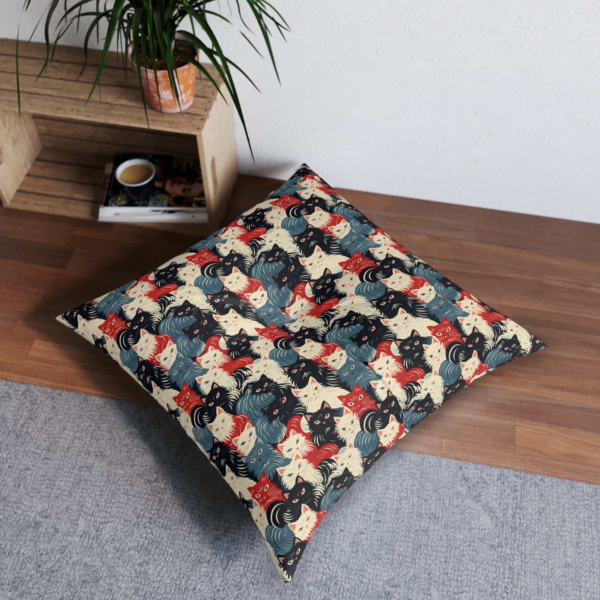 Indoor Square Floor Pillow - A bold and graphic pop art style illustration featuring a tight-knit cluster of various fluffy felines in black, white, red, and blue.