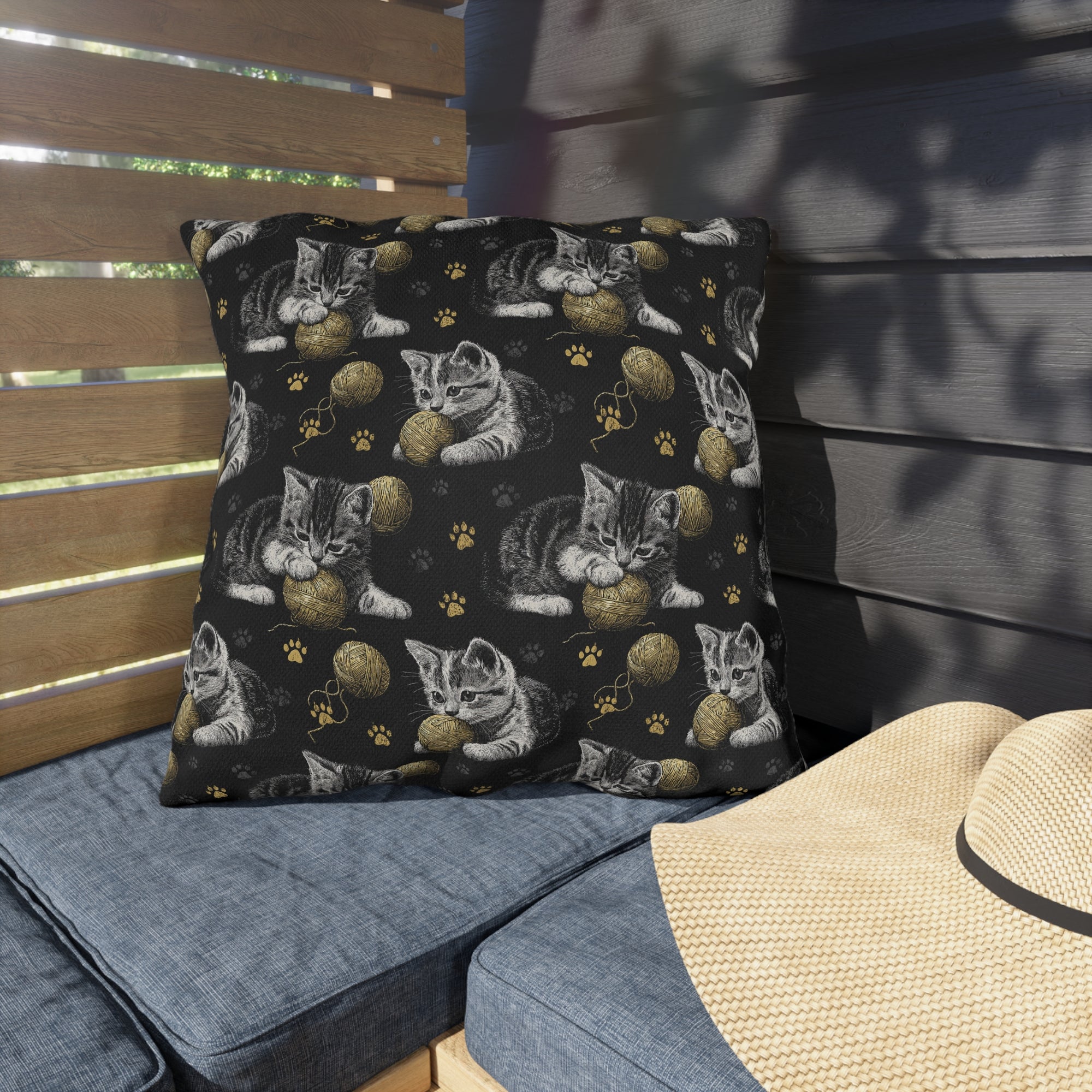 Outdoor Pillow - Grey and White Kittens Playing with Golden Yarn on a Black Background with Paw Prints