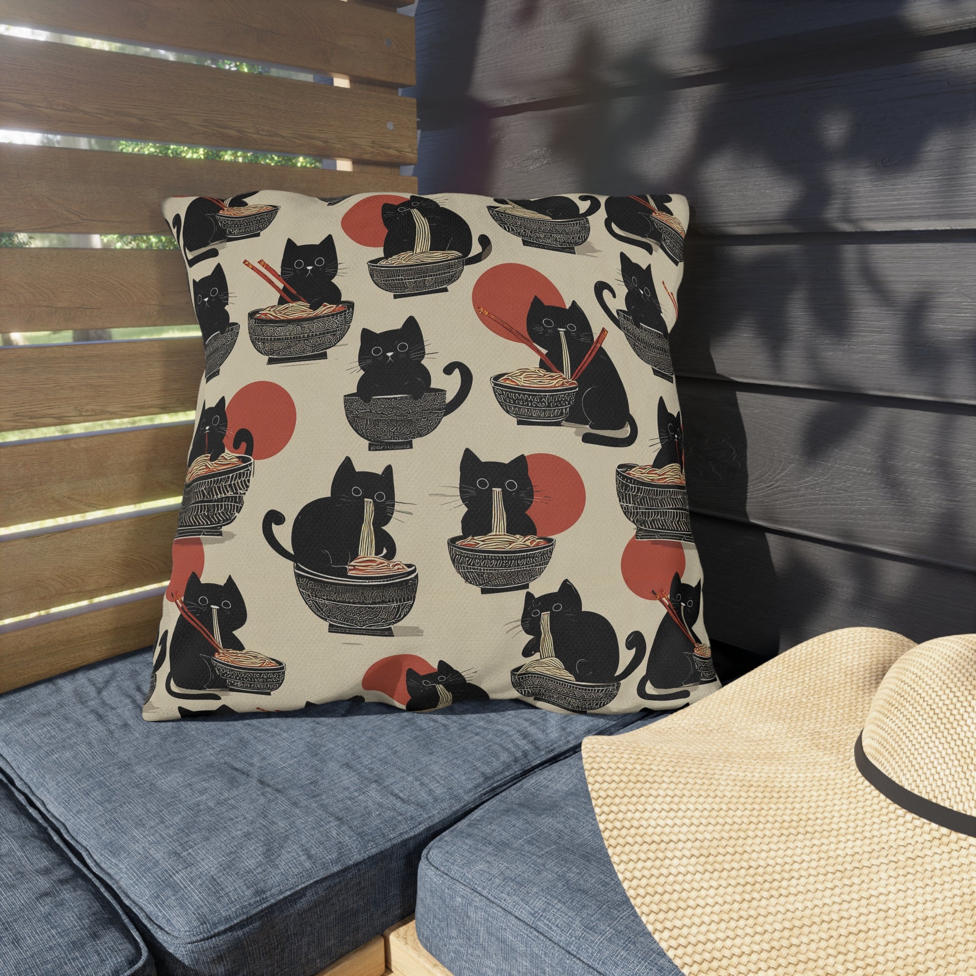 Outdoor Pillow - A whimsical and delightful hand-drawn style pattern of adorable black cats eating bowls of delicious ramen noodles with a large red sun in the background.