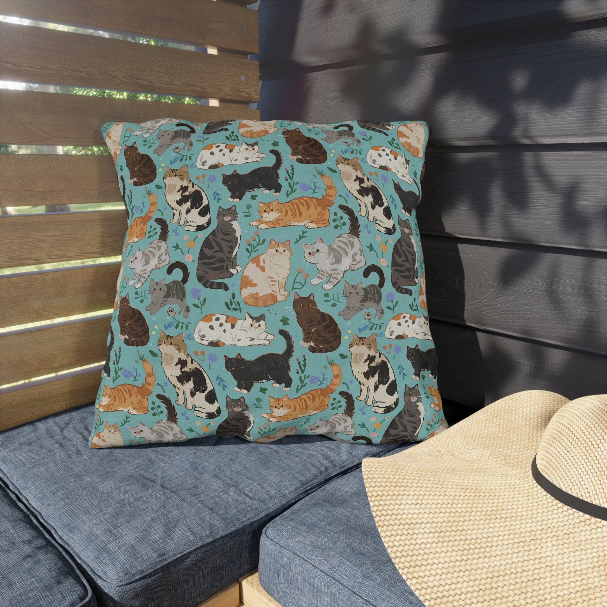 Outdoor Pillow - A Delightful Assortment of Charming Cats in Diverse Poses and Breeds Scattered Across a Soft Blue Floral Background