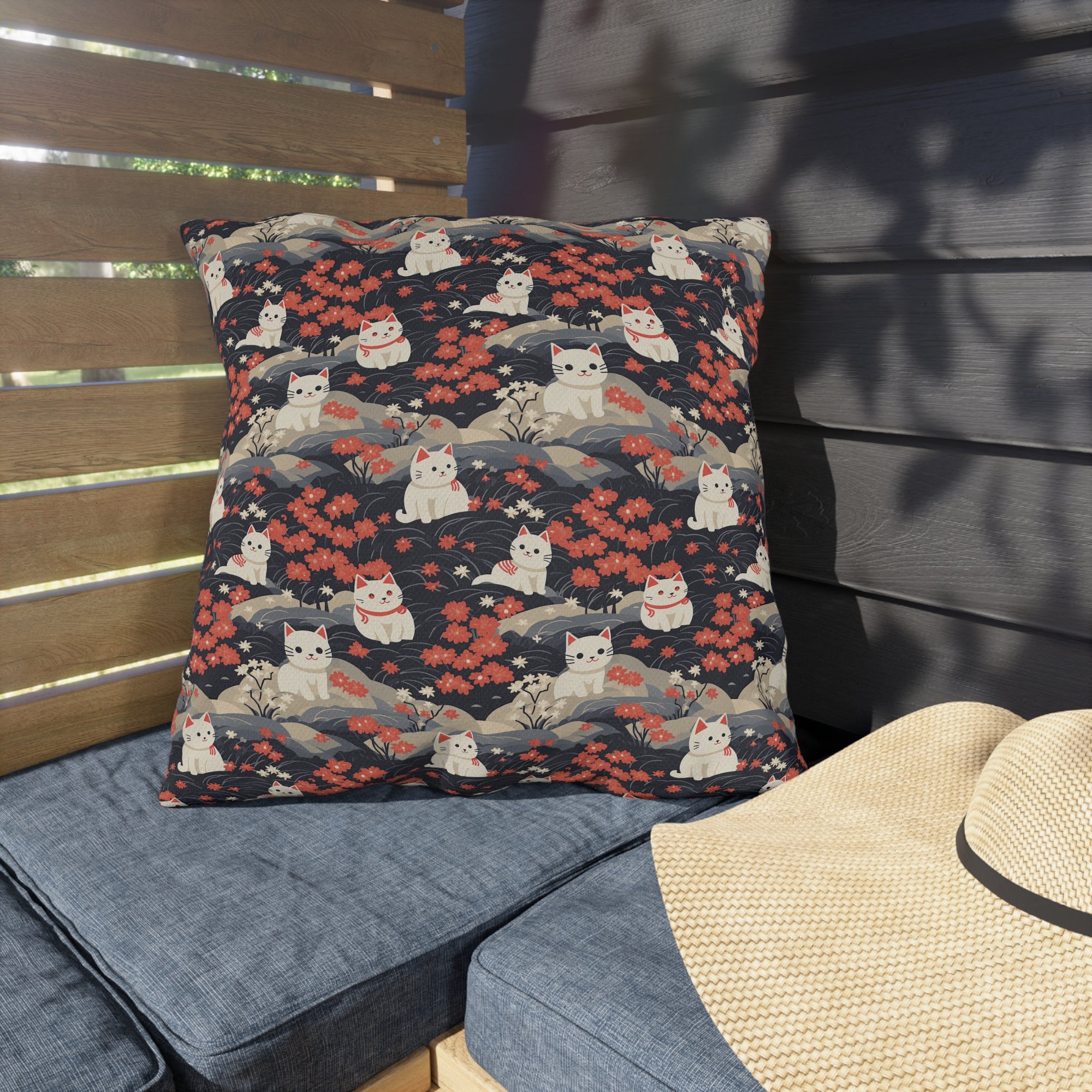 Outdoor Pillow - A charming, minimalist, Japanese-style illustration of cute white cats sitting amongst vibrant red and white flowers on a dark background.