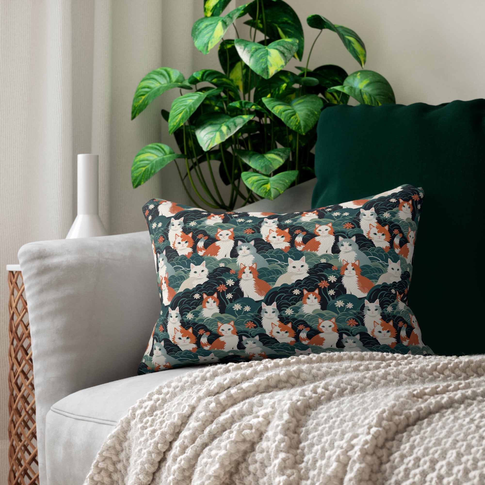 Indoor Lumbar Pillow - A whimsical, fluffy, watercolor depiction of various cats of different colors peeking out from a dense dark blue and green bush with white flowers.