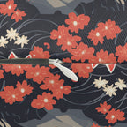 Indoor Lumbar Pillow - A charming, minimalist, Japanese-style illustration of cute white cats sitting amongst vibrant red and white flowers on a dark background.