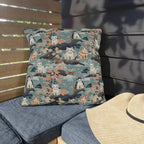 Outdoor Pillow - A serene watercolor painting of fluffy cats lounging on rocks, surrounded by cherry blossoms and blue water, in a tranquil, nature-filled, Japanese-inspired landscape.