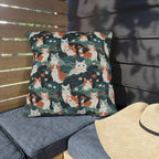 Outdoor Pillow - A whimsical, fluffy, watercolor depiction of various cats of different colors peeking out from a dense dark blue and green bush with white flowers.