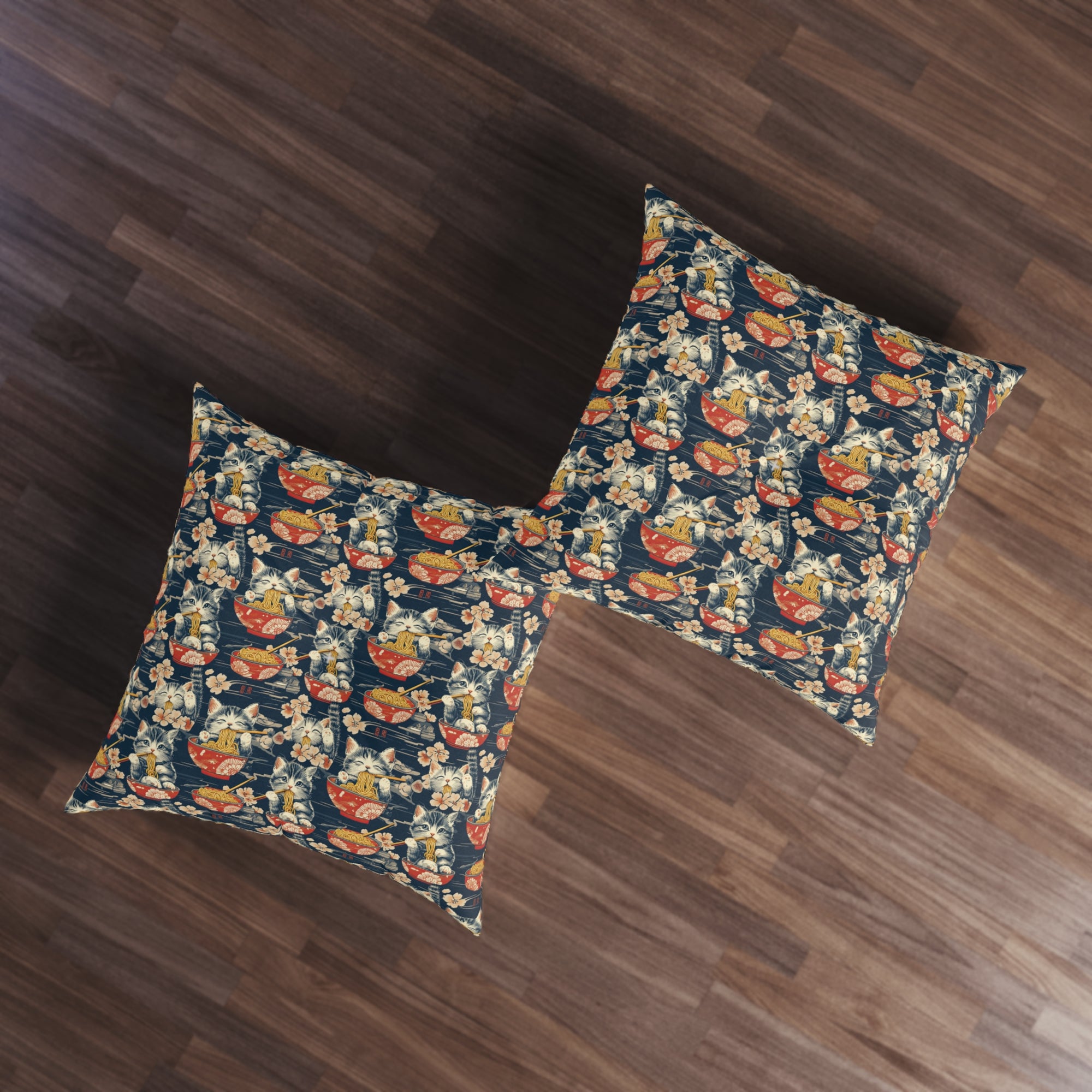 Indoor Square Floor Pillow - A charming and detailed illustration of happy kittens in red ramen bowls eating their noodles with chopsticks among beautiful pink cherry blossoms on a dark background.
