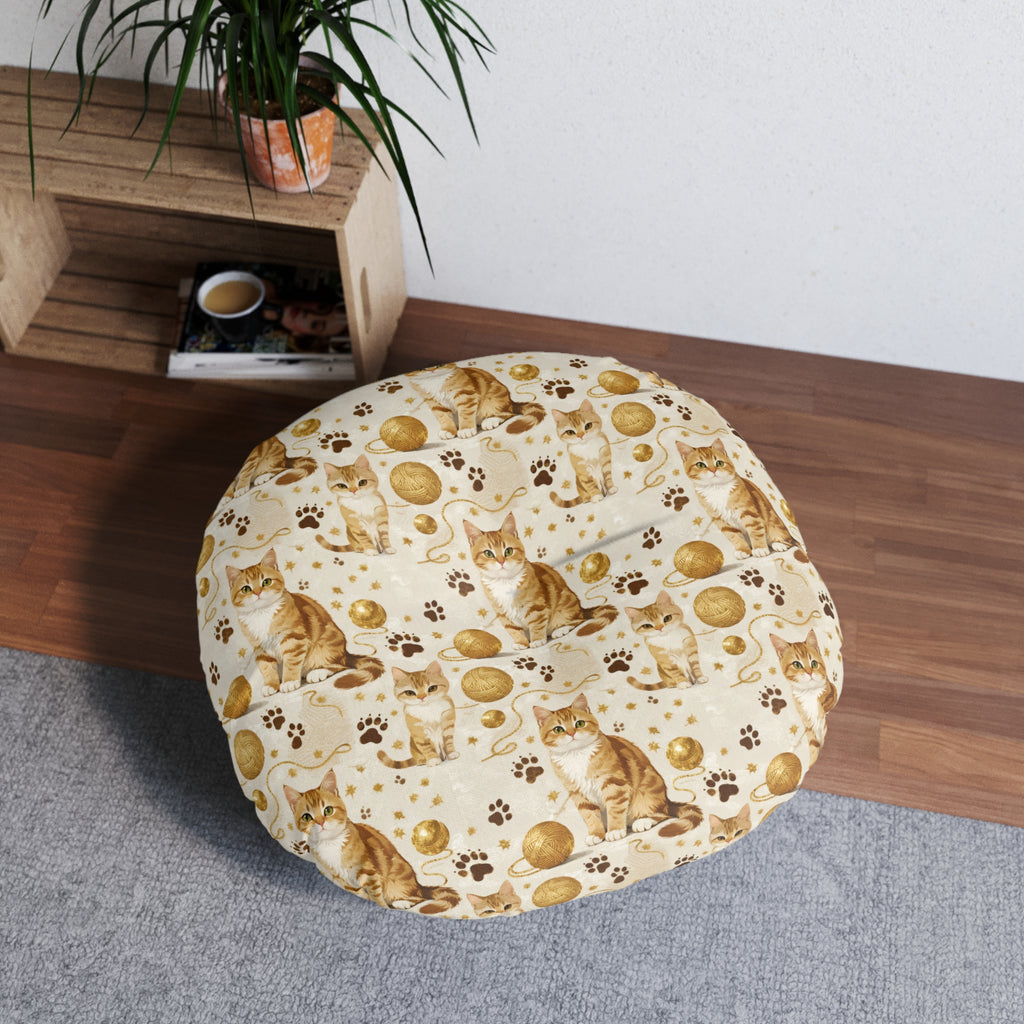 Indoor Round Floor Pillow - Adorable ginger cat with bright green eyes, sparkling gold yarn and paw prints, classic tabby cat illustration, cream background, cute and charming pet themed art