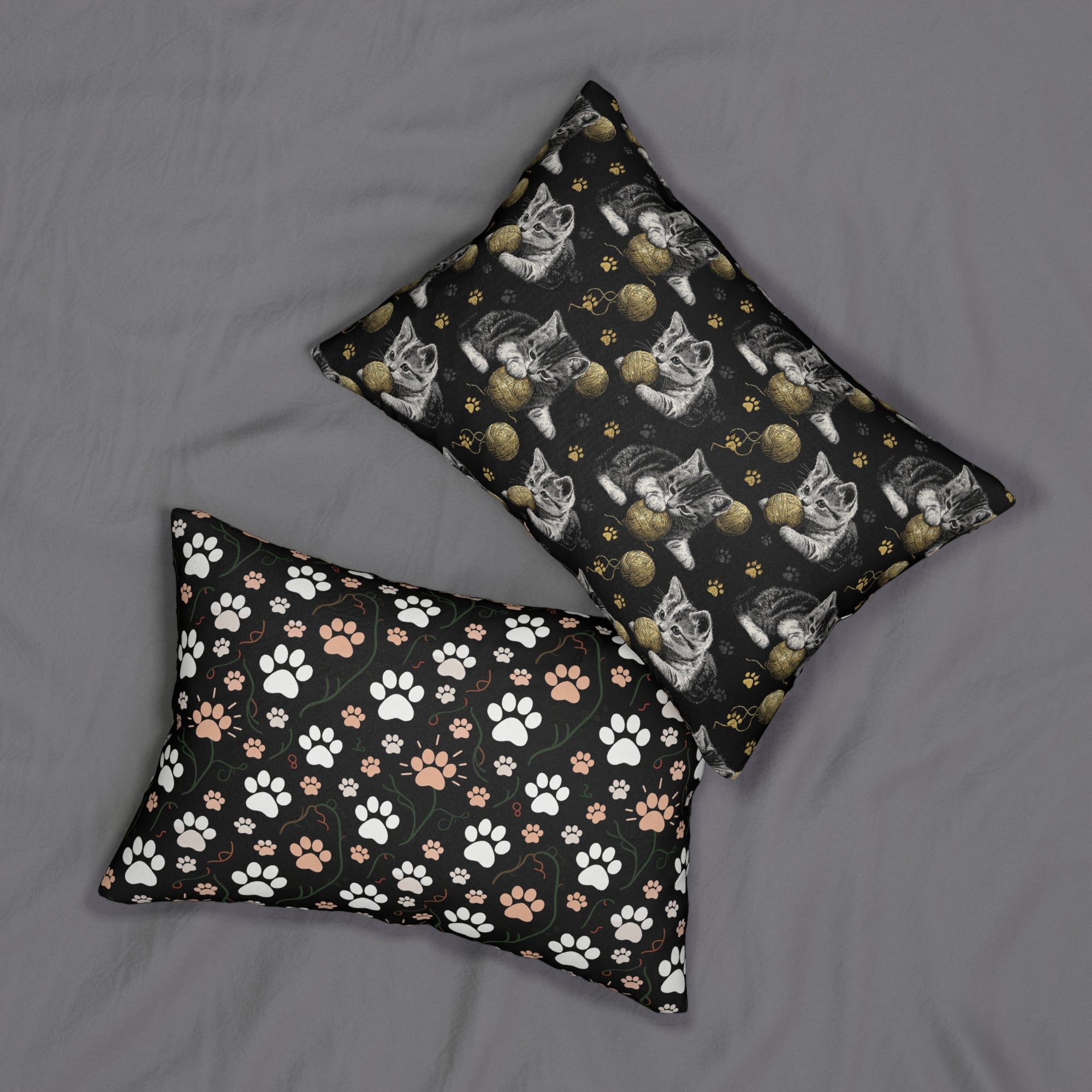 Indoor Lumbar Pillow - Grey and White Kittens Playing with Golden Yarn on a Black Background with Paw Prints