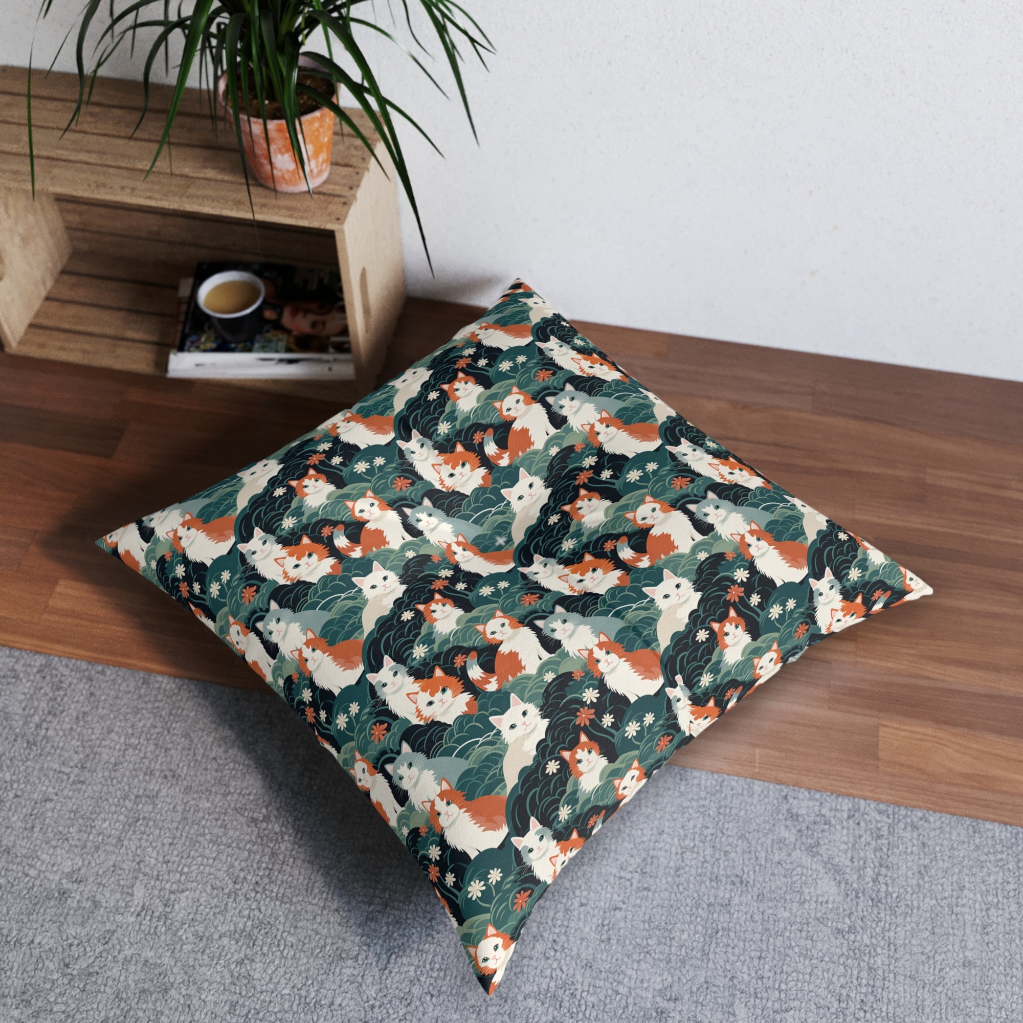 Indoor Square Floor Pillow - A whimsical, fluffy, watercolor depiction of various cats of different colors peeking out from a dense dark blue and green bush with white flowers.