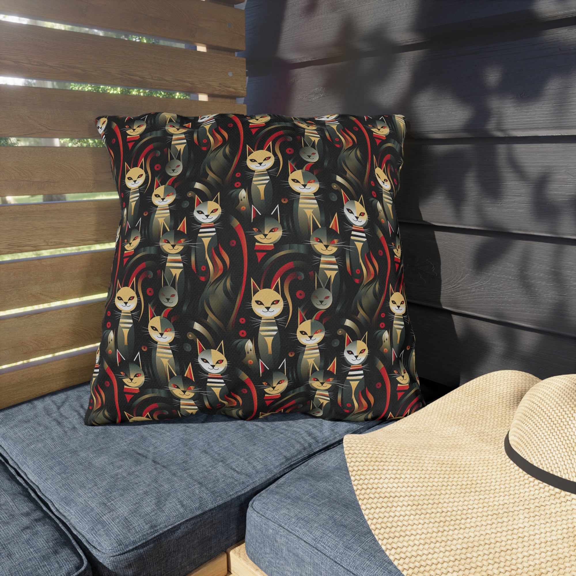 Outdoor Pillow - A bold and striking Art Deco pattern showcasing stylized feline portraits with sharp, gold lines and geometric shapes set against a dark, dramatic background.
