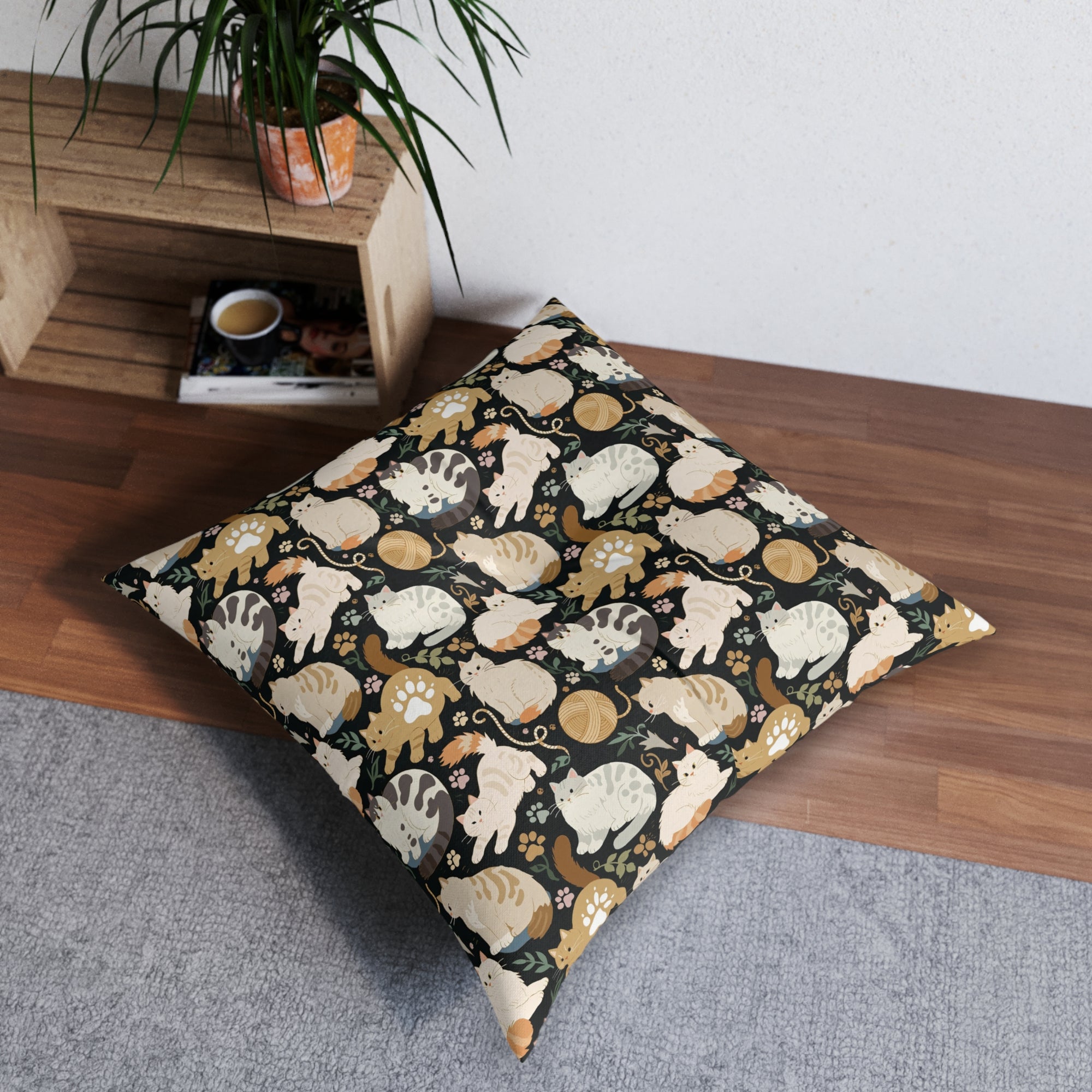Indoor Square Floor Pillow - Diverse cats and kittens in a dark garden, various breeds and colors, soft natural tones with foliage and paw prints, charming animal illustration, dark background, gentle pet themed art