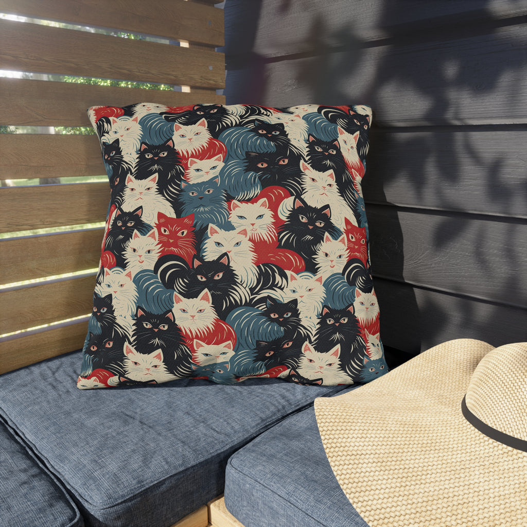 Outdoor Pillow - A bold and graphic pop art style illustration featuring a tight-knit cluster of various fluffy felines in black, white, red, and blue.