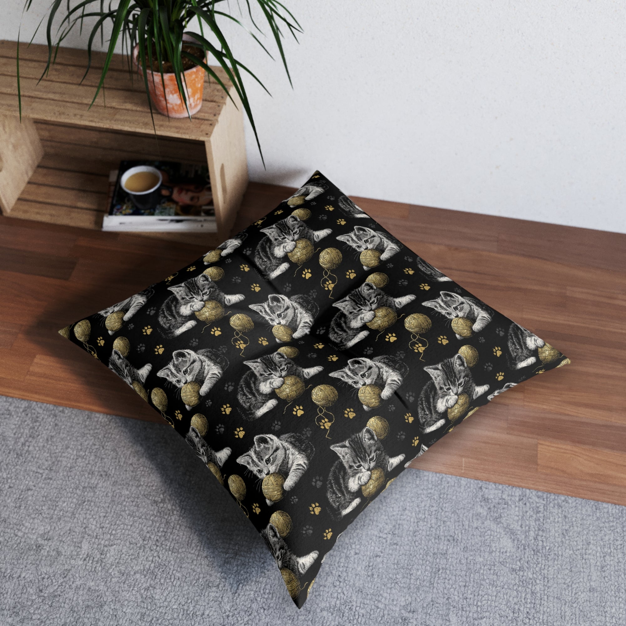 Indoor Square Floor Pillow - Grey and White Kittens Playing with Golden Yarn on a Black Background with Paw Prints