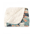 Sherpa Blanket - A serene watercolor painting of fluffy cats lounging on rocks, surrounded by cherry blossoms and blue water, in a tranquil, nature-filled, Japanese-inspired landscape.