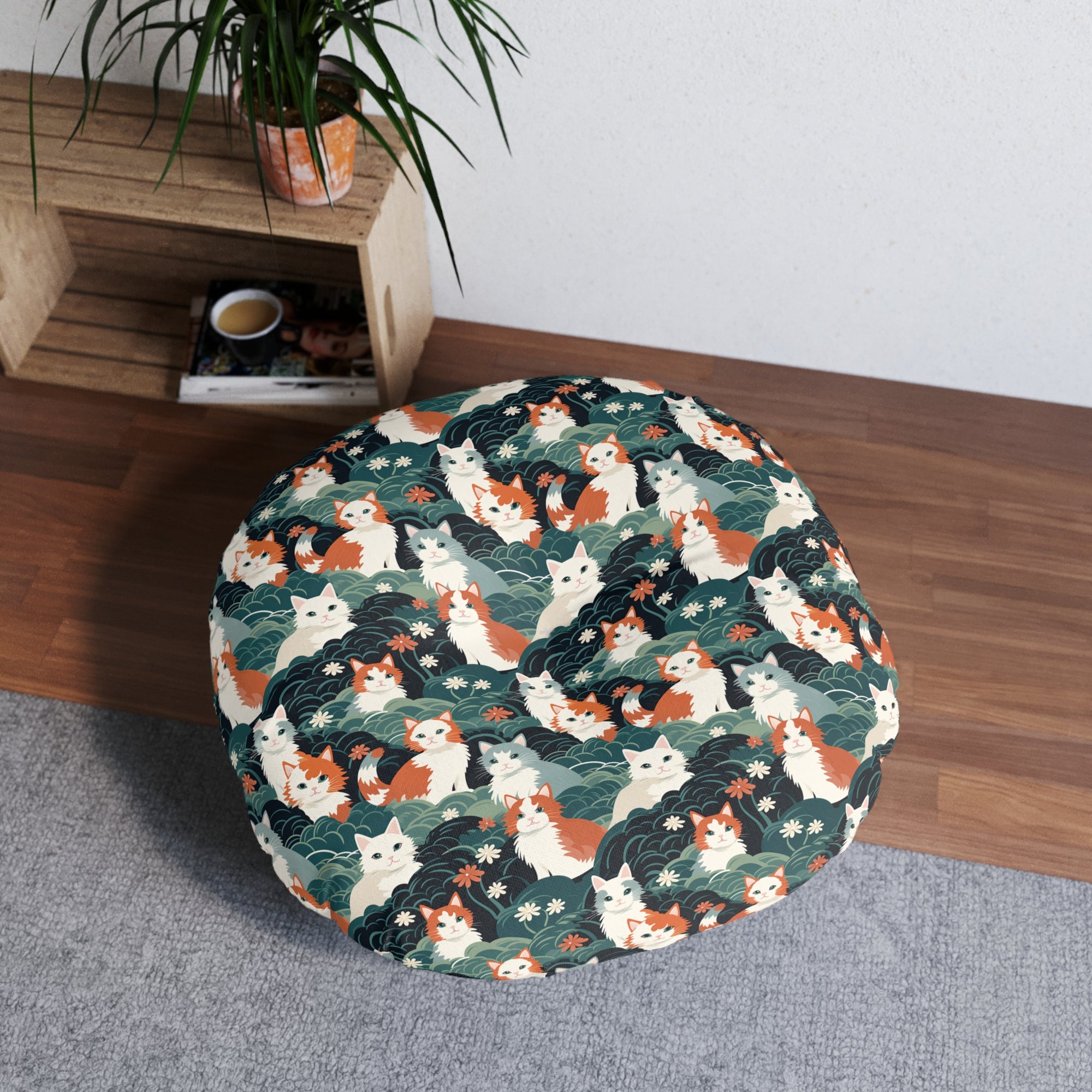 Indoor Round Floor Pillow - A whimsical, fluffy, watercolor depiction of various cats of different colors peeking out from a dense dark blue and green bush with white flowers.
