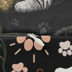 Indoor Lumbar Pillow - Grey and White Kittens Playing with Golden Yarn on a Black Background with Paw Prints