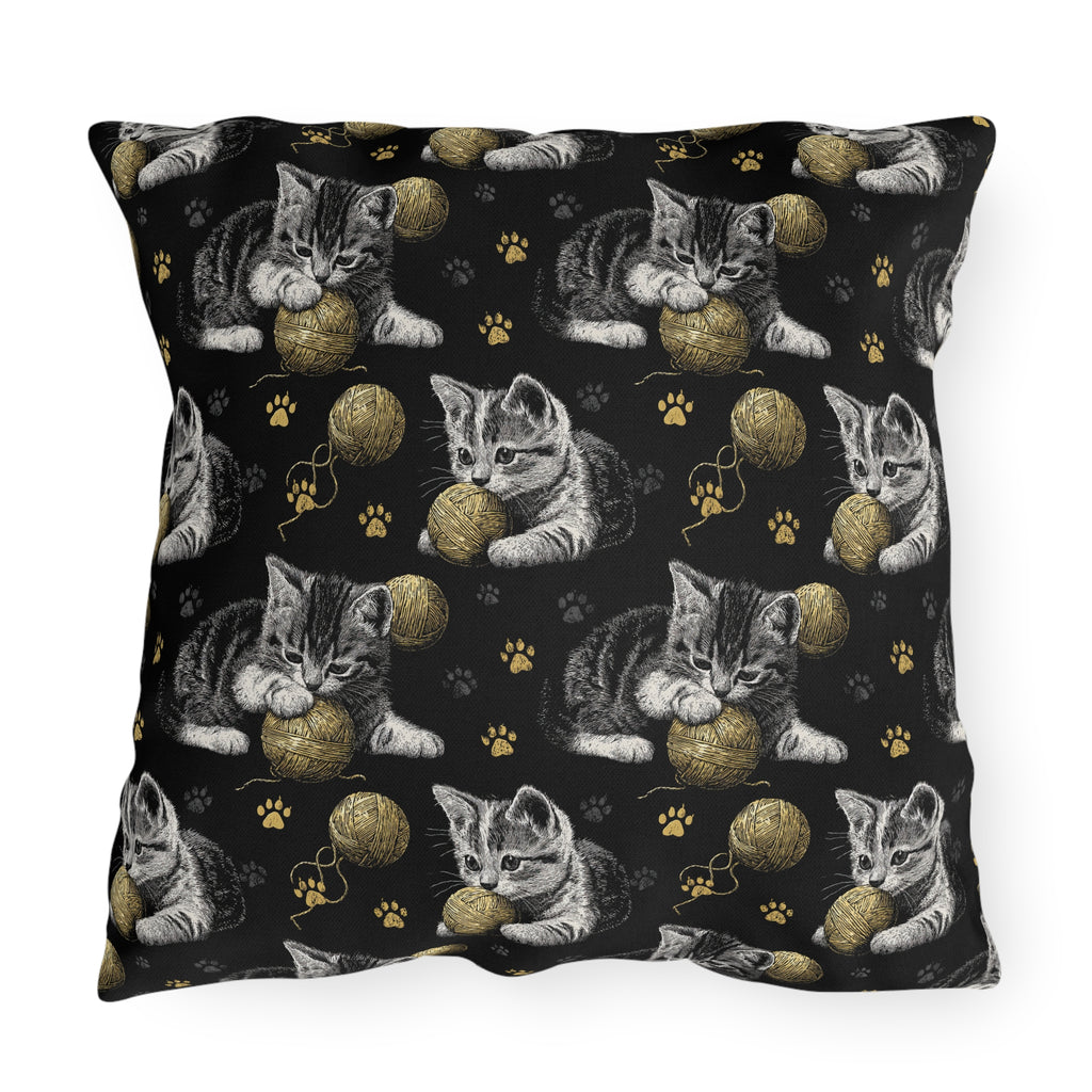 Outdoor Pillow - Grey and White Kittens Playing with Golden Yarn on a Black Background with Paw Prints