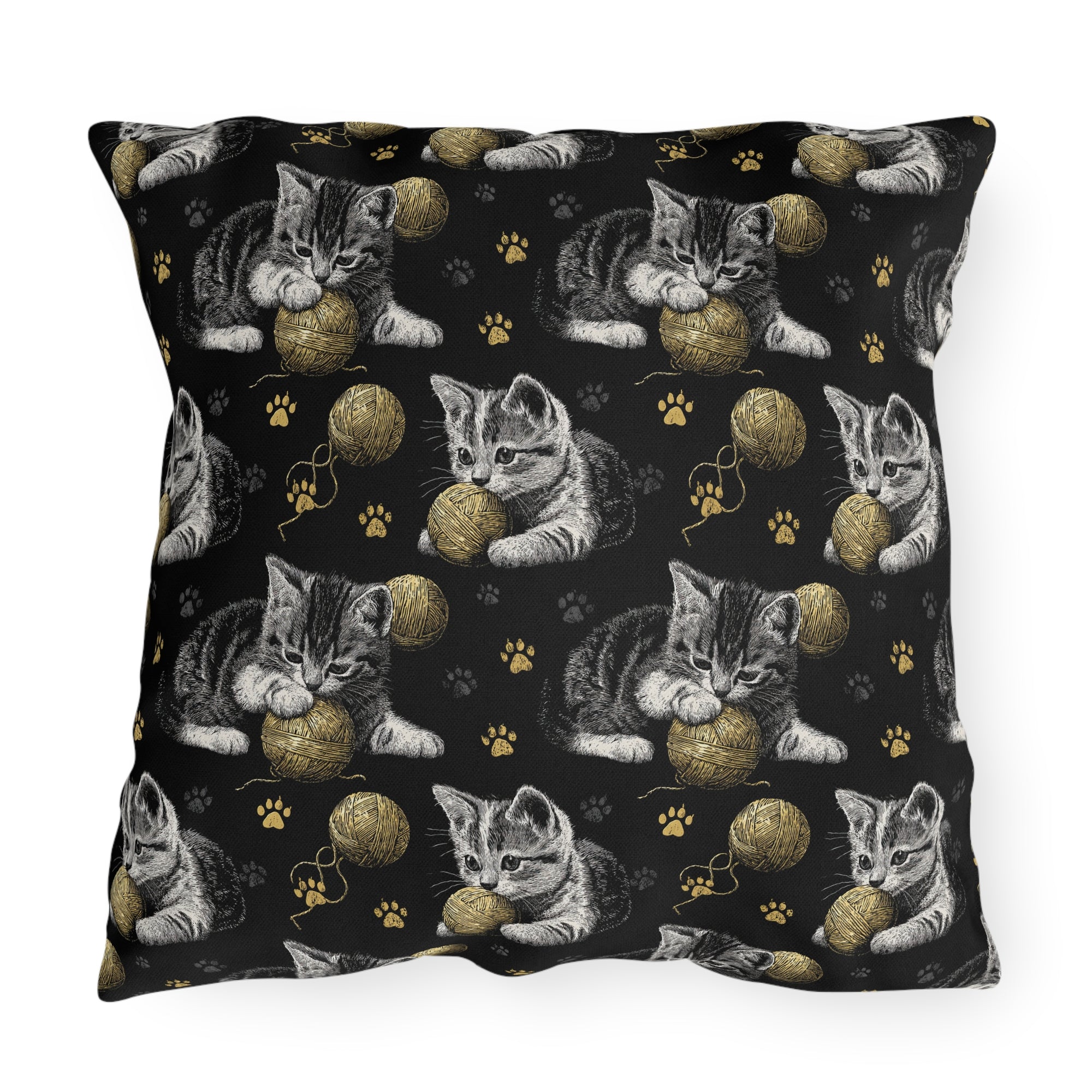 Outdoor Pillow - Grey and White Kittens Playing with Golden Yarn on a Black Background with Paw Prints