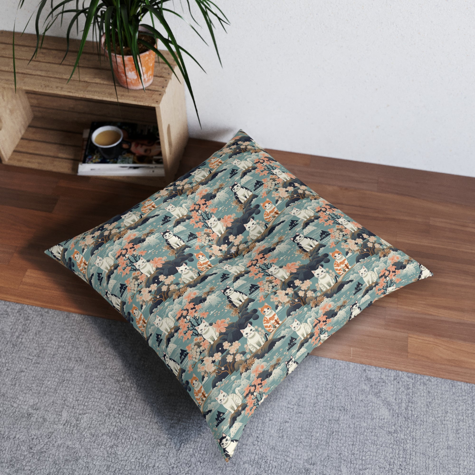 Indoor Square Floor Pillow - A serene watercolor painting of fluffy cats lounging on rocks, surrounded by cherry blossoms and blue water, in a tranquil, nature-filled, Japanese-inspired landscape.
