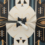 Indoor Lumbar Pillow - An elegant and artistic Art Deco-style pattern featuring streamlined white cats with a striking geometric backdrop of golden and black lines and shapes.